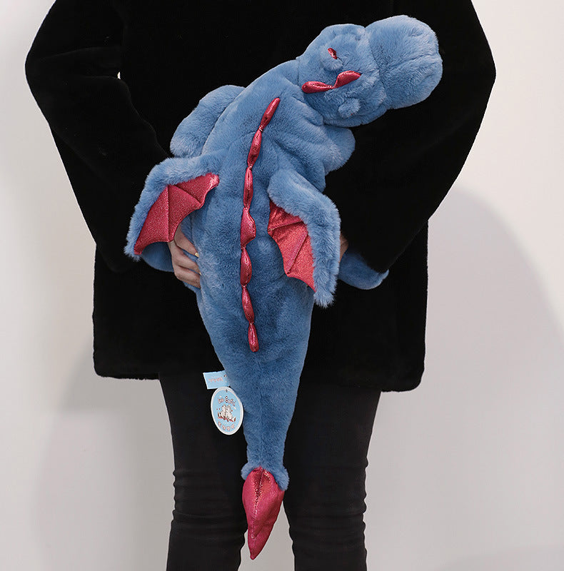 peluche lestee dragon bleu dans dos