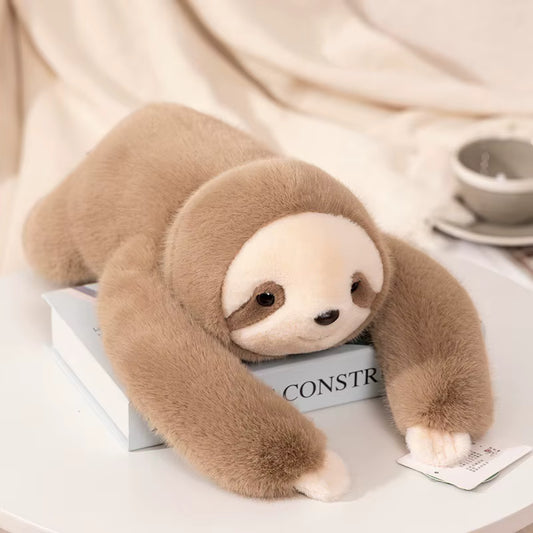 peluche lestee paresseux sur livre